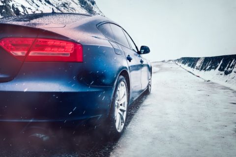 rear view of sedan parked on a snowy road