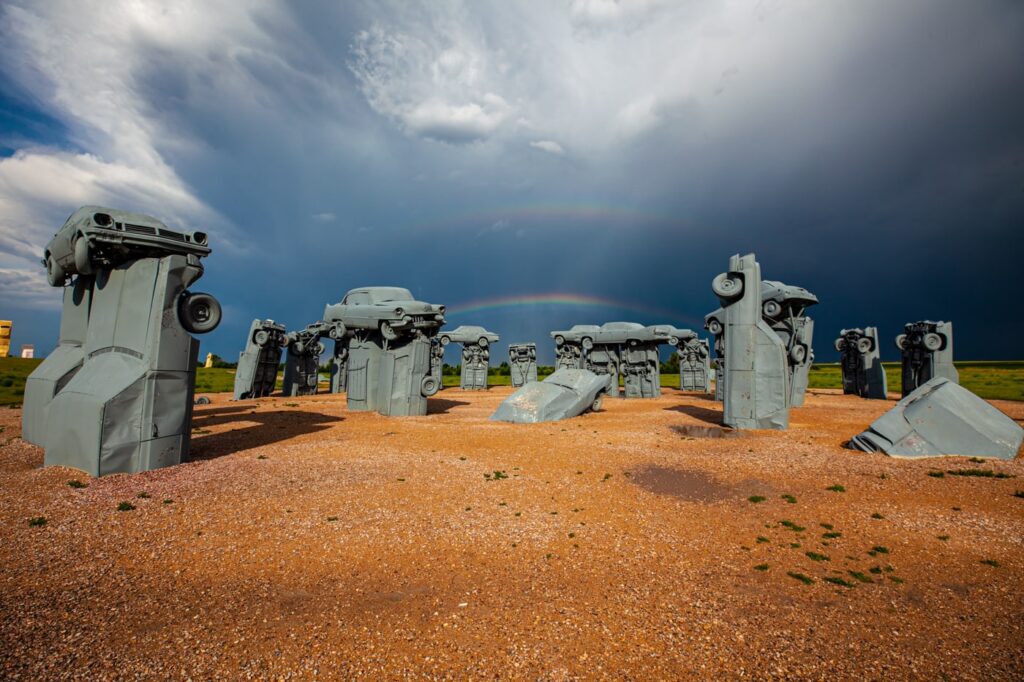 Carhenge with double rainbow in background